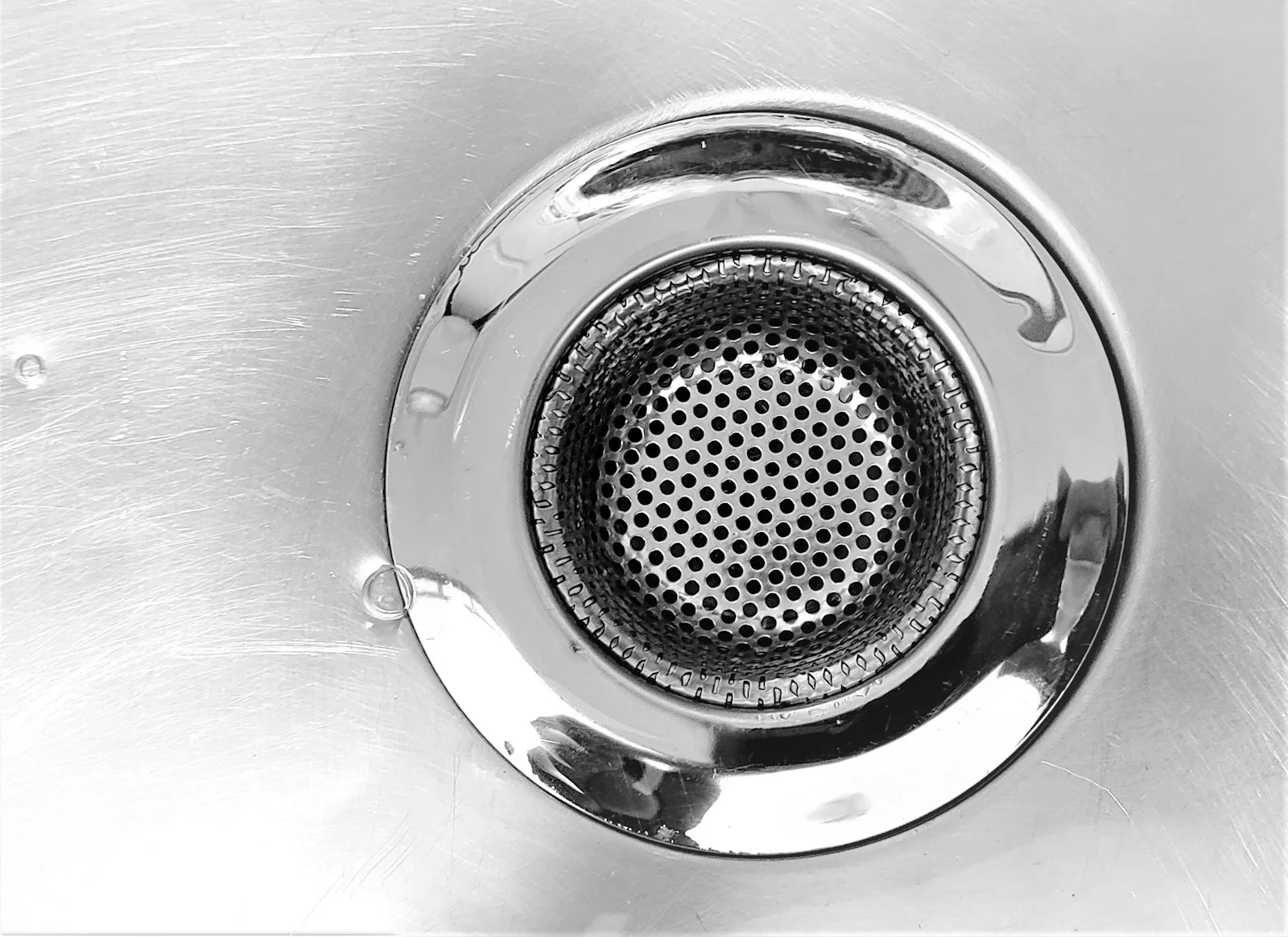 Close view of a stainless kitchen sink drain