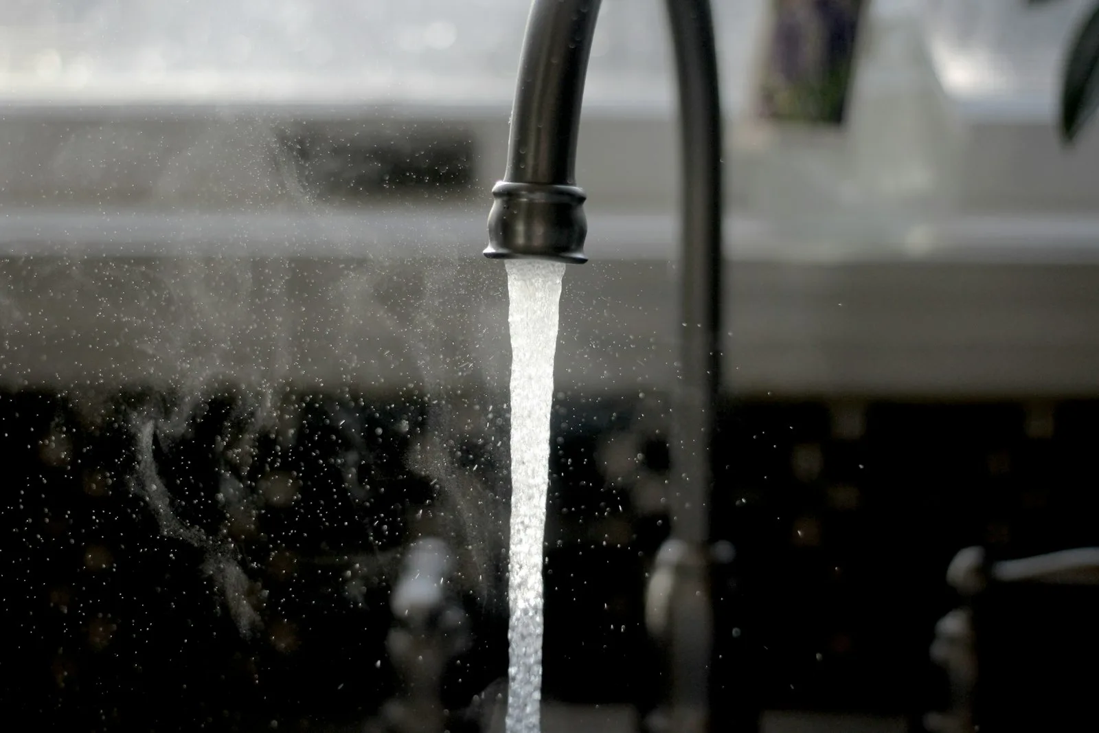 Water running from a faucet into a sink