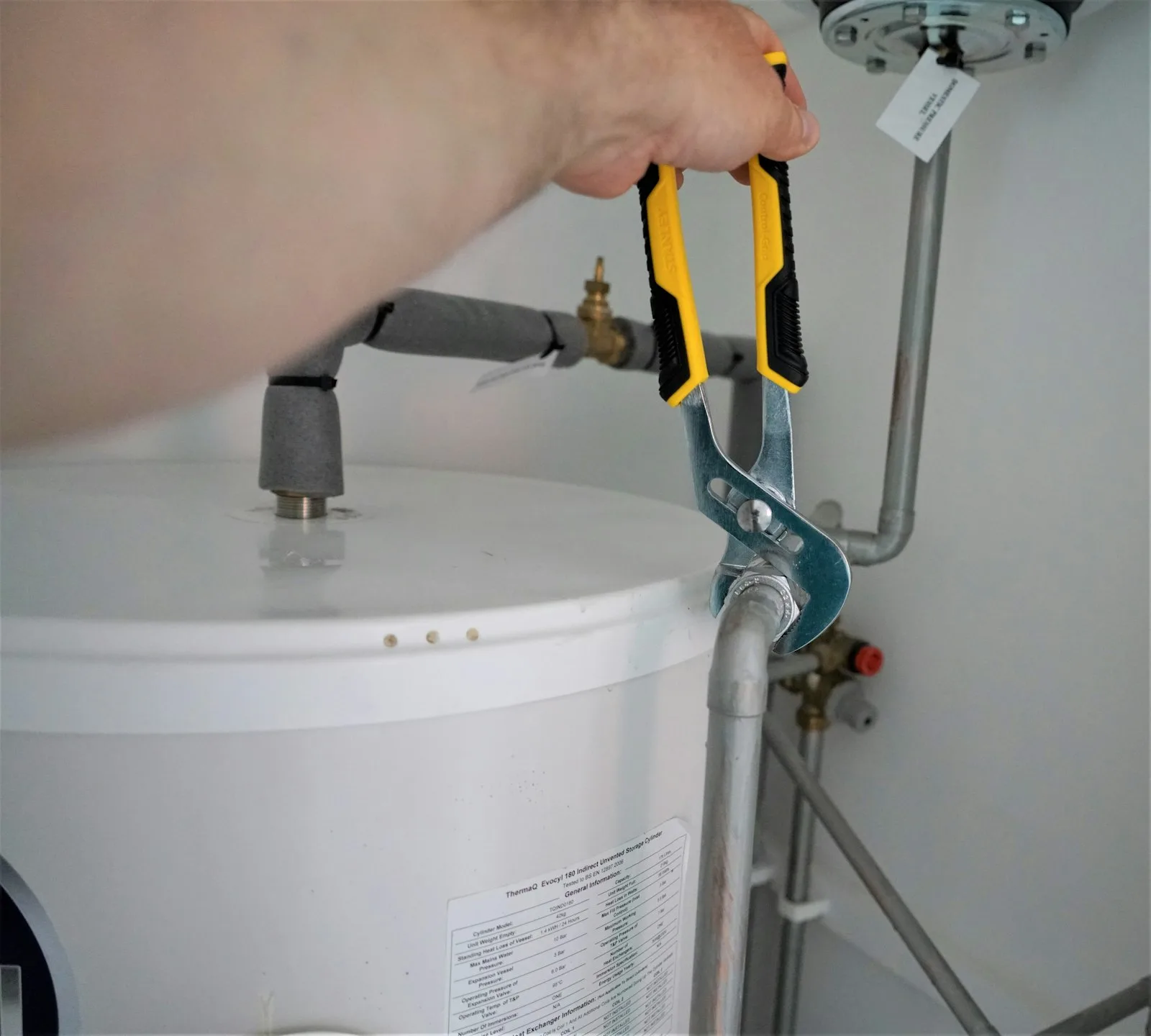 Hand tool being used on a plumbing connection